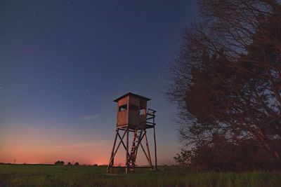 Tower on field against sky at night