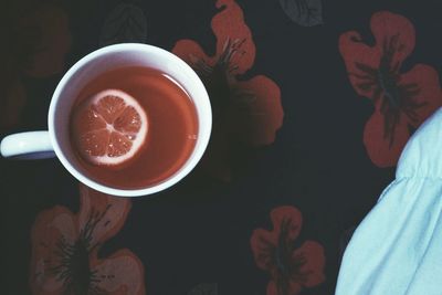 Low section of woman with drink on table