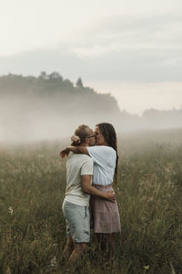 Couple kissing on meadow