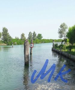 Scenic view of lake against clear blue sky