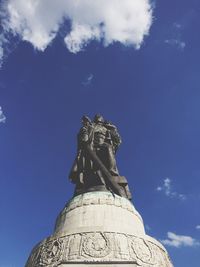 Low angle view of statue against blue sky