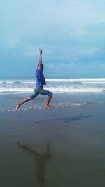 Man surfing in sea against sky