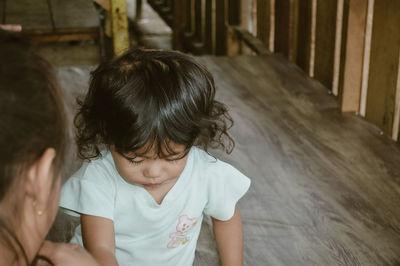 High angle view of boy sitting on staircase