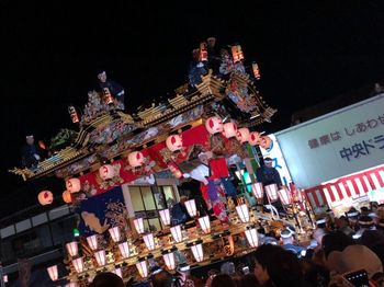 Low angle view of illuminated lanterns against sky at night