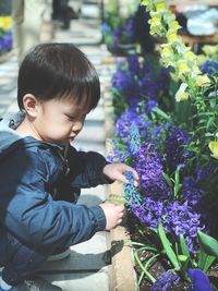 Side view of woman on purple flowering plants
