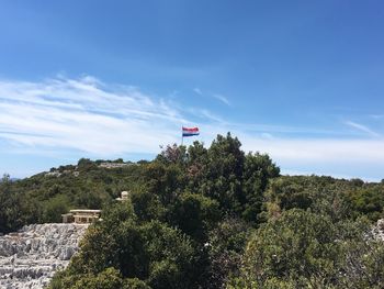 Scenic view of flag against sky