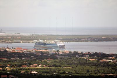 High angle view of buildings and sea against sky