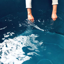 High angle view of hands in water