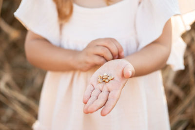 Midsection of woman holding flower