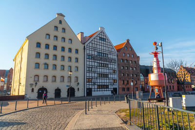 Buildings in city against clear sky