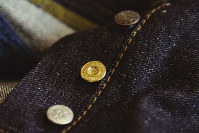 High angle view of various buttons on jeans