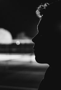 Close-up portrait of a silhouette woman against blurred background