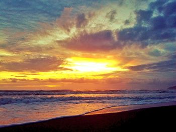 Scenic view of beach against sky during sunset
