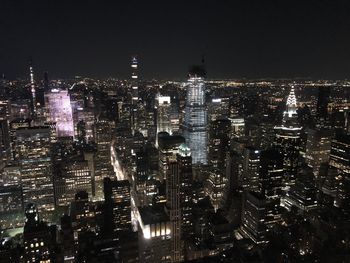 Aerial view of illuminated buildings in city at night
