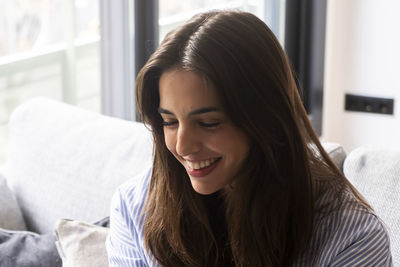 Close-up of young woman looking at home