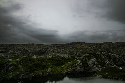 Scenic view of waterfall against sky