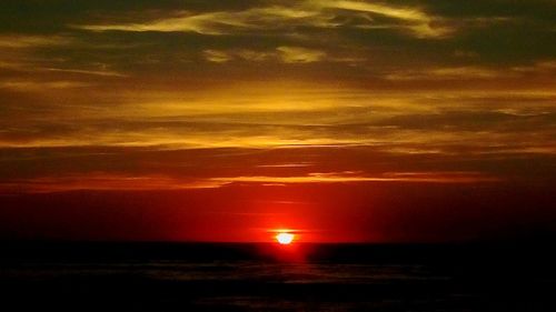 Scenic view of sea against romantic sky at sunset