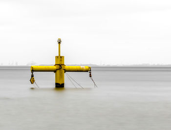 Lifeguard hut on sea against sky