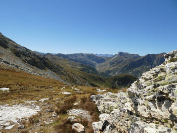 Scenic view of rocky mountains against clear blue sky