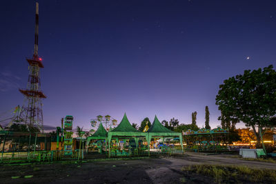 Panoramic view of illuminated building against clear sky at night