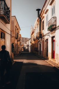 People on street amidst buildings in city