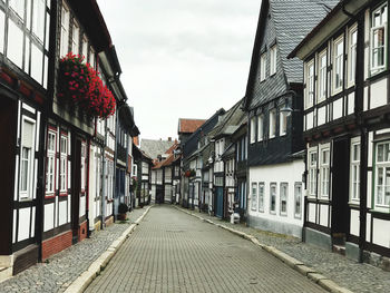 Empty alley amidst buildings in town