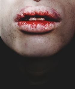 Close-up of woman lips against black background