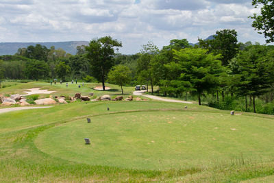 Scenic view of golf course against sky