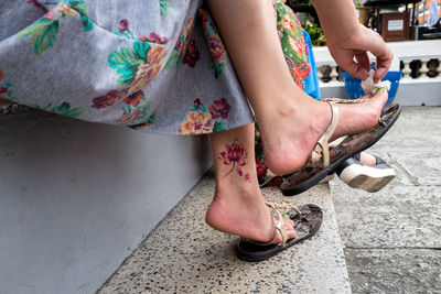 Low section of woman standing outdoors