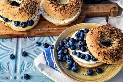 Sliced bagels filled with cream cheese and fresh whole blueberries