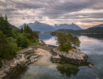 Scenic view of lake and mountains against sky