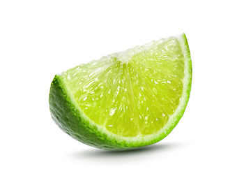 Close-up of lemon slice against white background