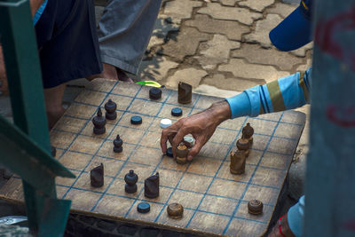 Friends playing board game on footpath