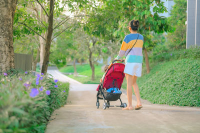 Full length of woman walking on footpath