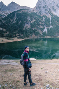 Full length of man standing near a lake
