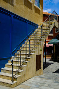 Staircase of building against blue sky