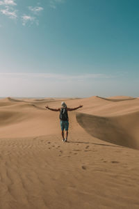 Rear view of man standing in desert