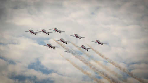 Low angle view of airshow against sky