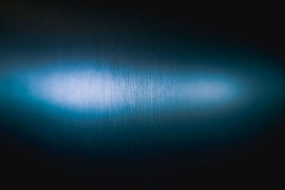 Defocused image of illuminated lights against black background