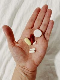 Cropped hand of woman holding pills