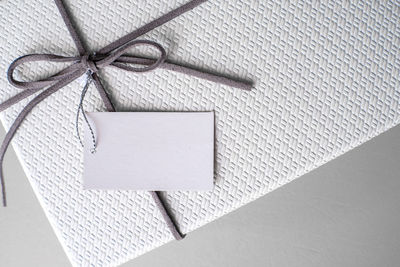 High angle view of paper tied up on white box