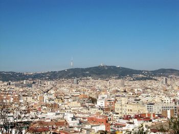 High angle shot of townscape against blue sky