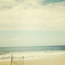 Scenic view of sea against cloudy sky