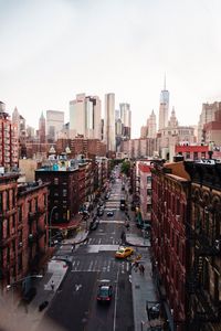 High angle view of street amidst buildings in city against sky