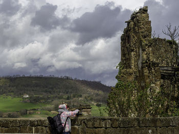 People on mountain against sky