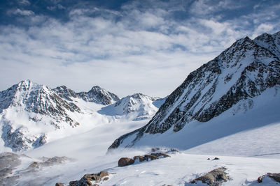 Scenic view of snow covered mountains against sky