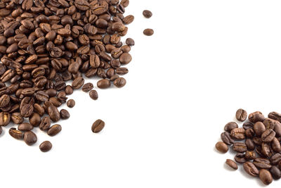High angle view of coffee beans against white background