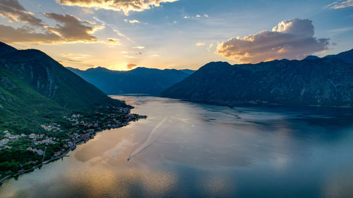 Photo of sunset in the boko kotor bay, night city lights