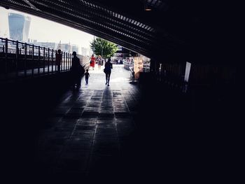 People walking on bridge in city