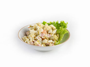 Close-up of salad in plate against white background